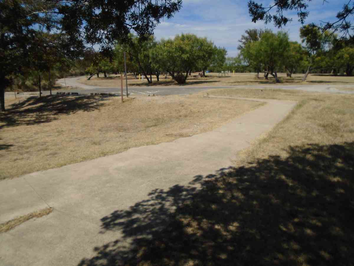 The paved wheelchair accessible.walkway to Walk-in Campsite #219 and #220.