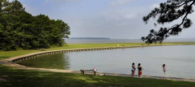 Wheelchair accessible cement route along the swimming area of the lake at Lake Livingston State Park. 