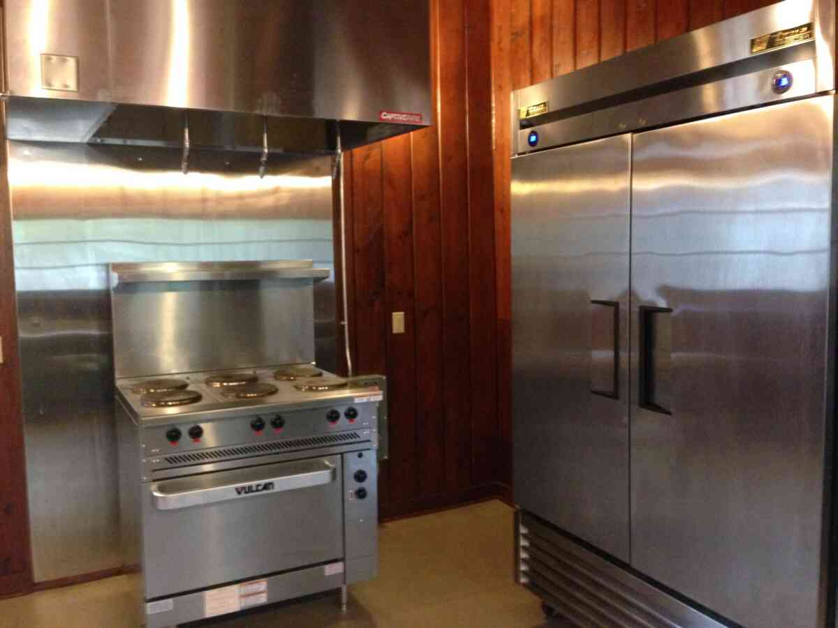 Looking at the stove/oven and the refrigerator in the kitchen.  