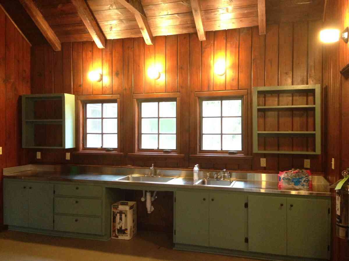 The kitchen has 2 sinks and lots of shelf space. 