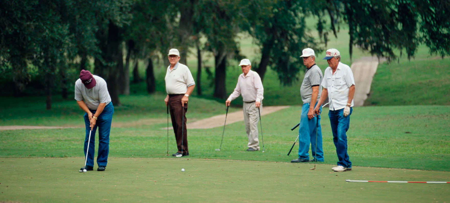 Group of Men Play Golf