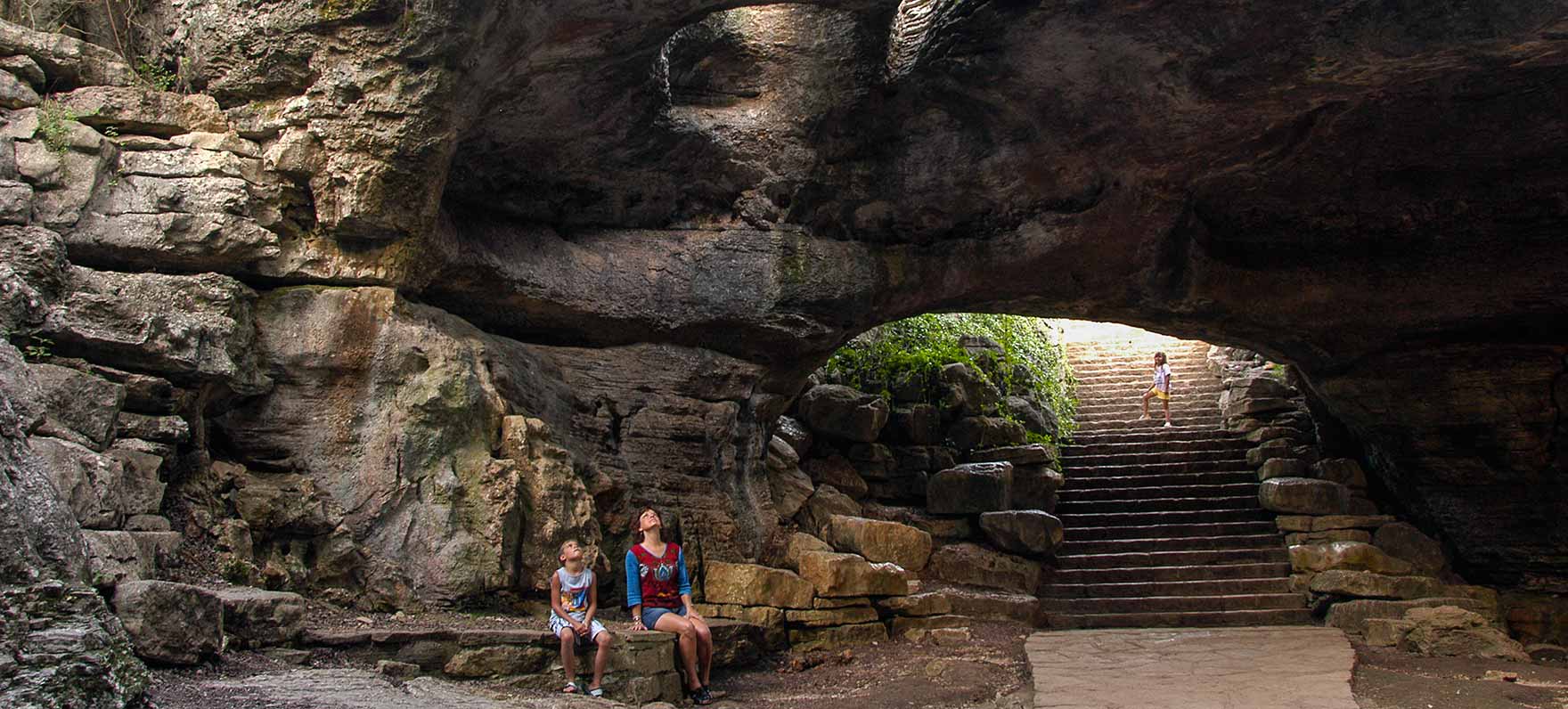 mother and daughter looking up thru hole