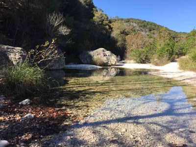 Nov. 15, 2016 photo of the pond reflecting shadows at Lost Maples State Natural Area, by Colette Nicholl