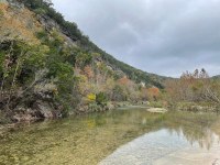Hillside with a bit of color above water 