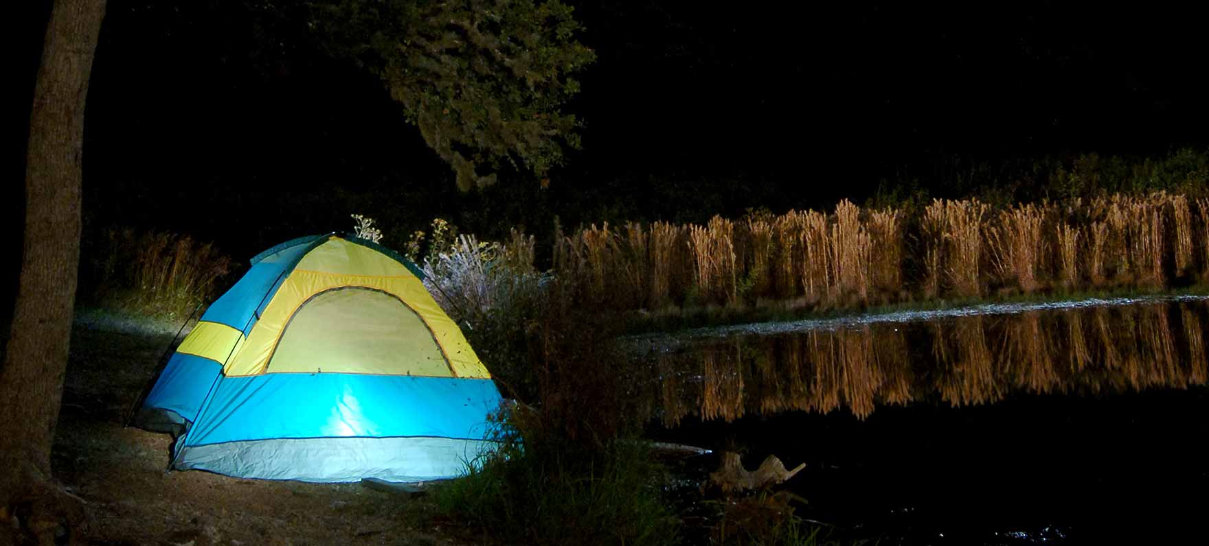 tent by shore at night