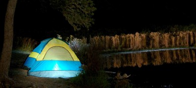 tent by shore at night