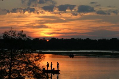 Fishermen in a small boat at sunset