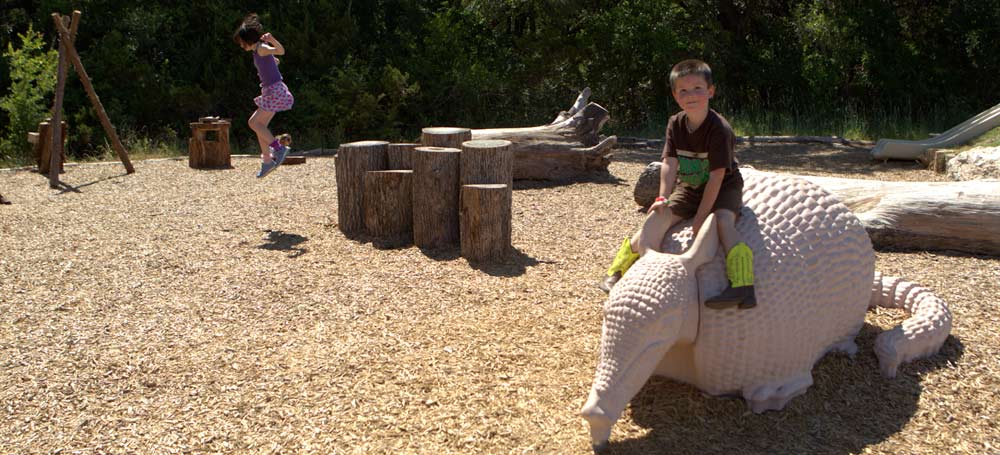 Kids playing on natural playground