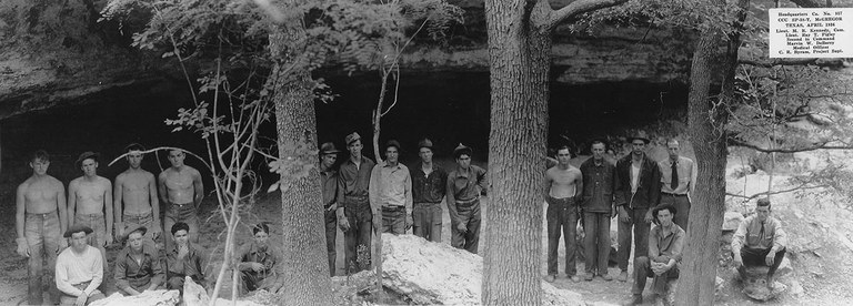 CCC workers standing in front of a cave.