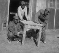 CCC workers working on table.