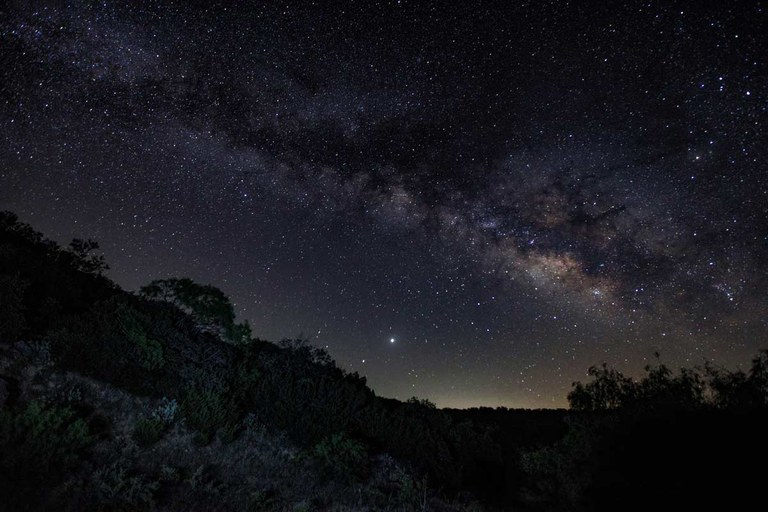 Photo of Milky Way over dark landscape