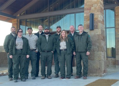 People in staff wear pose on a patio in at park headquarters