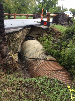 Damaged culvert, with part of road eroded