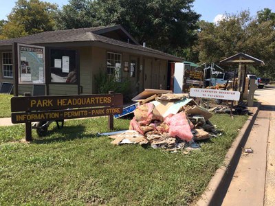 Flood damaged debris in front of park headquarters