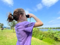 Girl looking through binoculars 