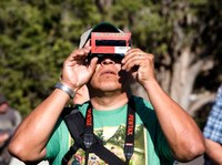 Person using solar viewing glasses.