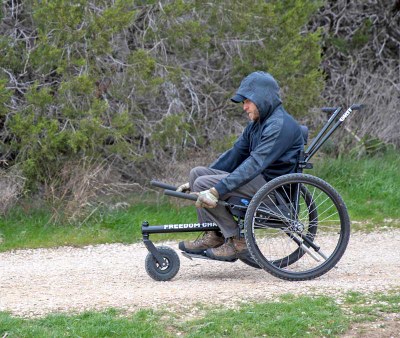 Man using a GRIT Freedom Chair on a trail.
