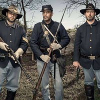 Three costumed Buffalo Soldier reenactors