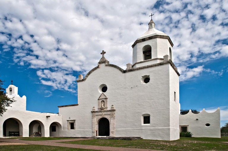 Exterior photo of white chapel against blue sky