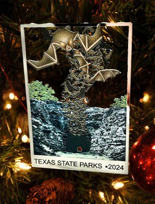 Ornament with bats flying up from a cave