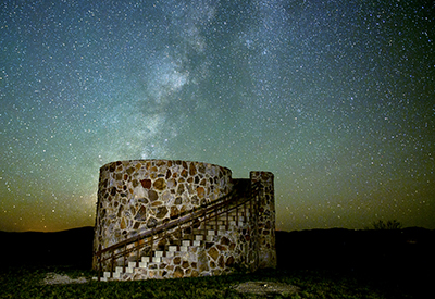 Night sky view over a lookout tower
