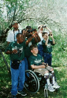 Group of boys using binoculars, one boy is in a wheelchair