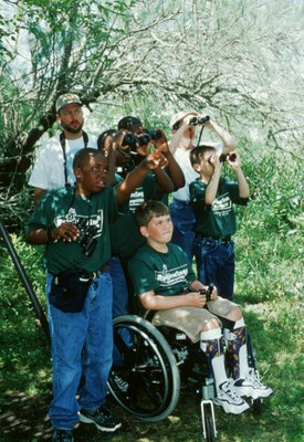 Group of boys using binoculars, one boy is in a wheelchair