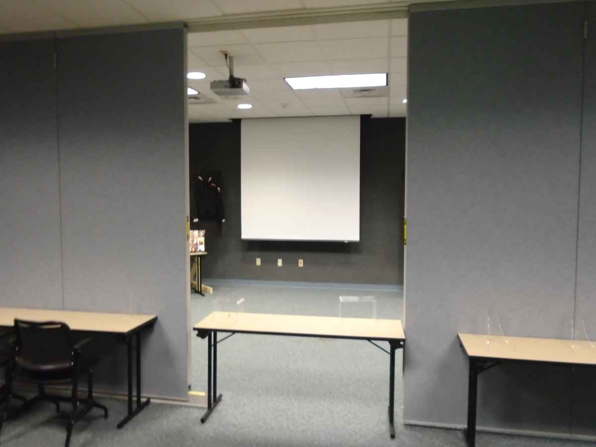 There is a projector and a projection screen inside the Meeting Room. 