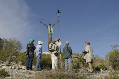 Hikers Around Shaman Sculpture
