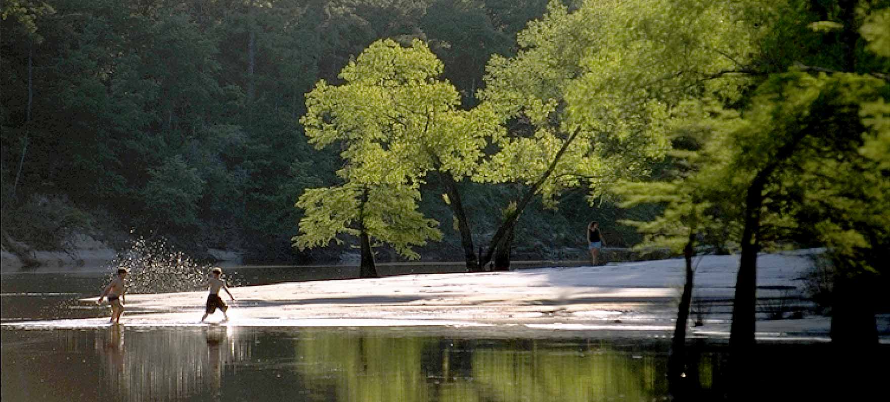 kids playing in by shore in Village Creek SP