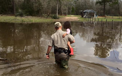 Game Warden carrying child in Flood.PNG