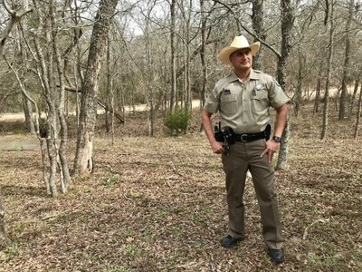 Game Warden Sonny Alaniz in the woods.jpg