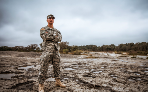 Military person standing on Enchanted Rock.PNG